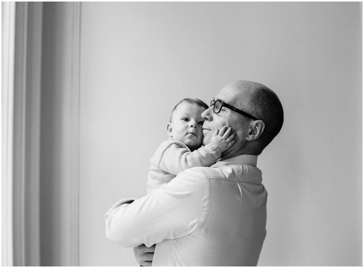 baby boy hugging his dad in family portrait
