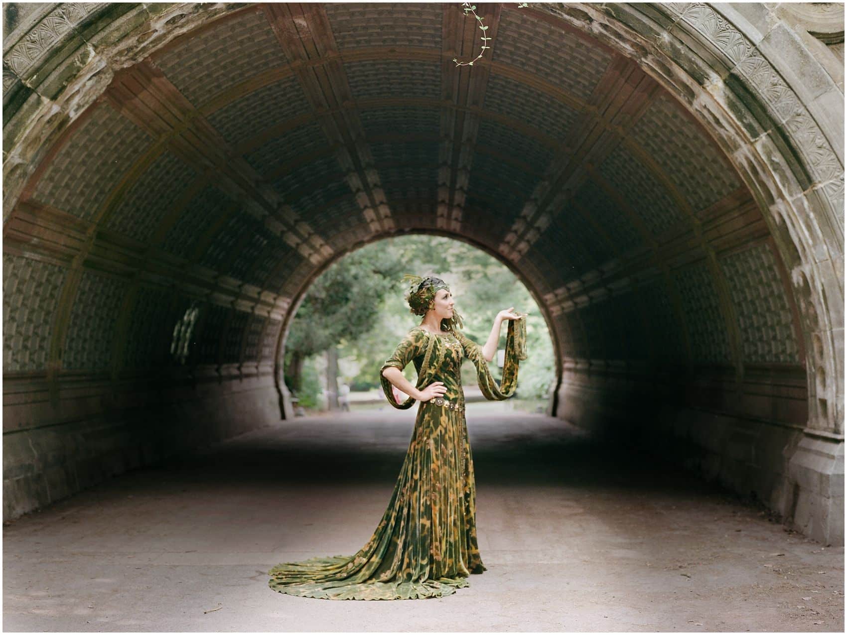 New mom posing under the arch of Prospect Park for the motherhood portraits in NYC