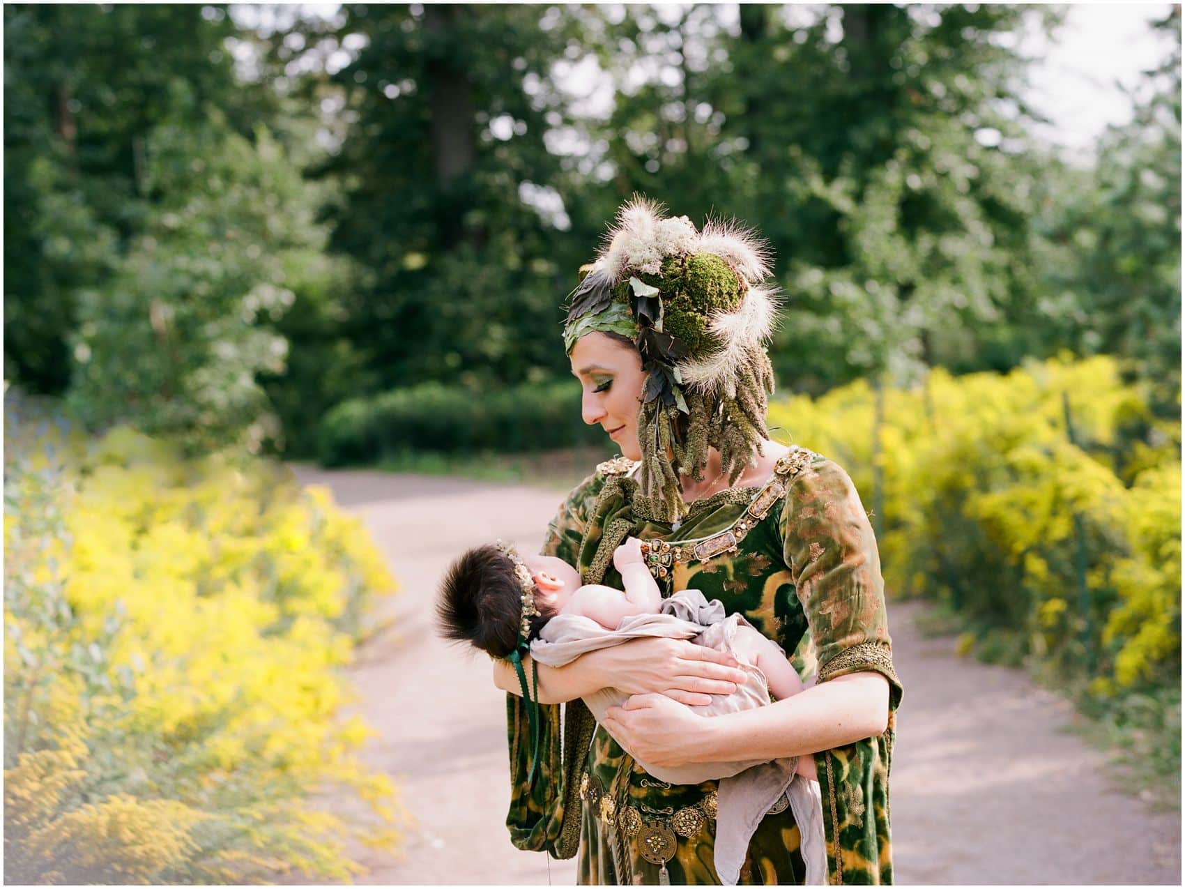 dream photo shoot of newborn photography NYC in yellow garden with a mother adoring her sleeping baby girl
