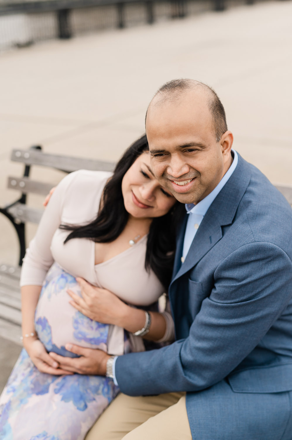 NYC maternity photographer session, couple embracing at waterfront