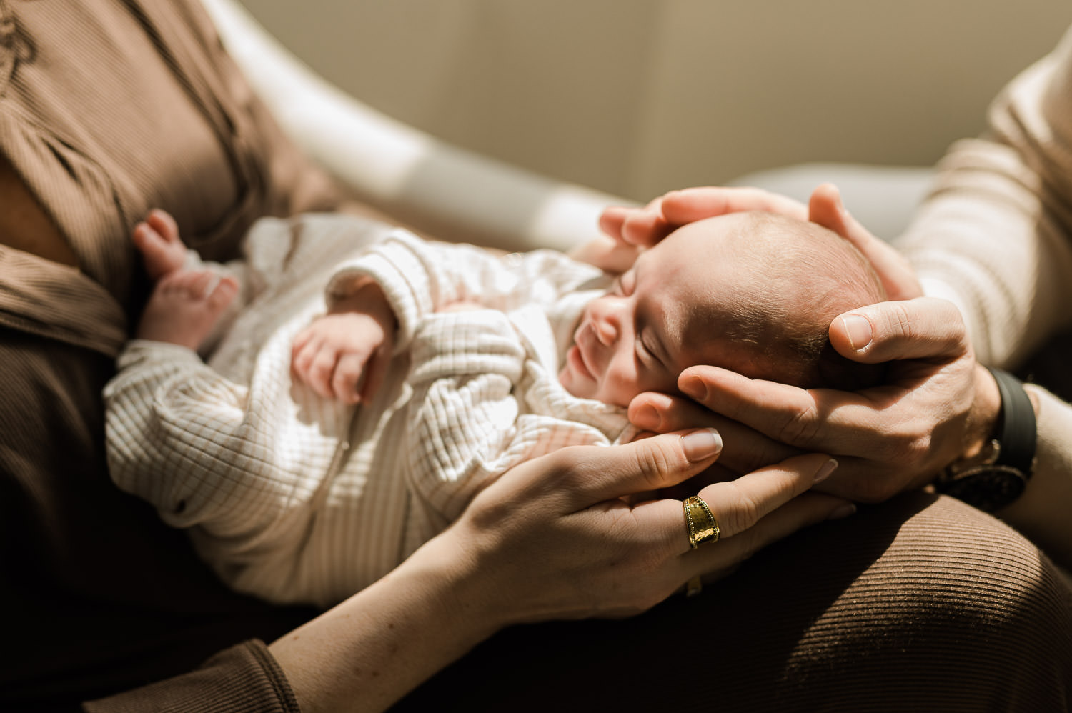 Both parents hands holding newborn baby together — in-home newborn session NJ