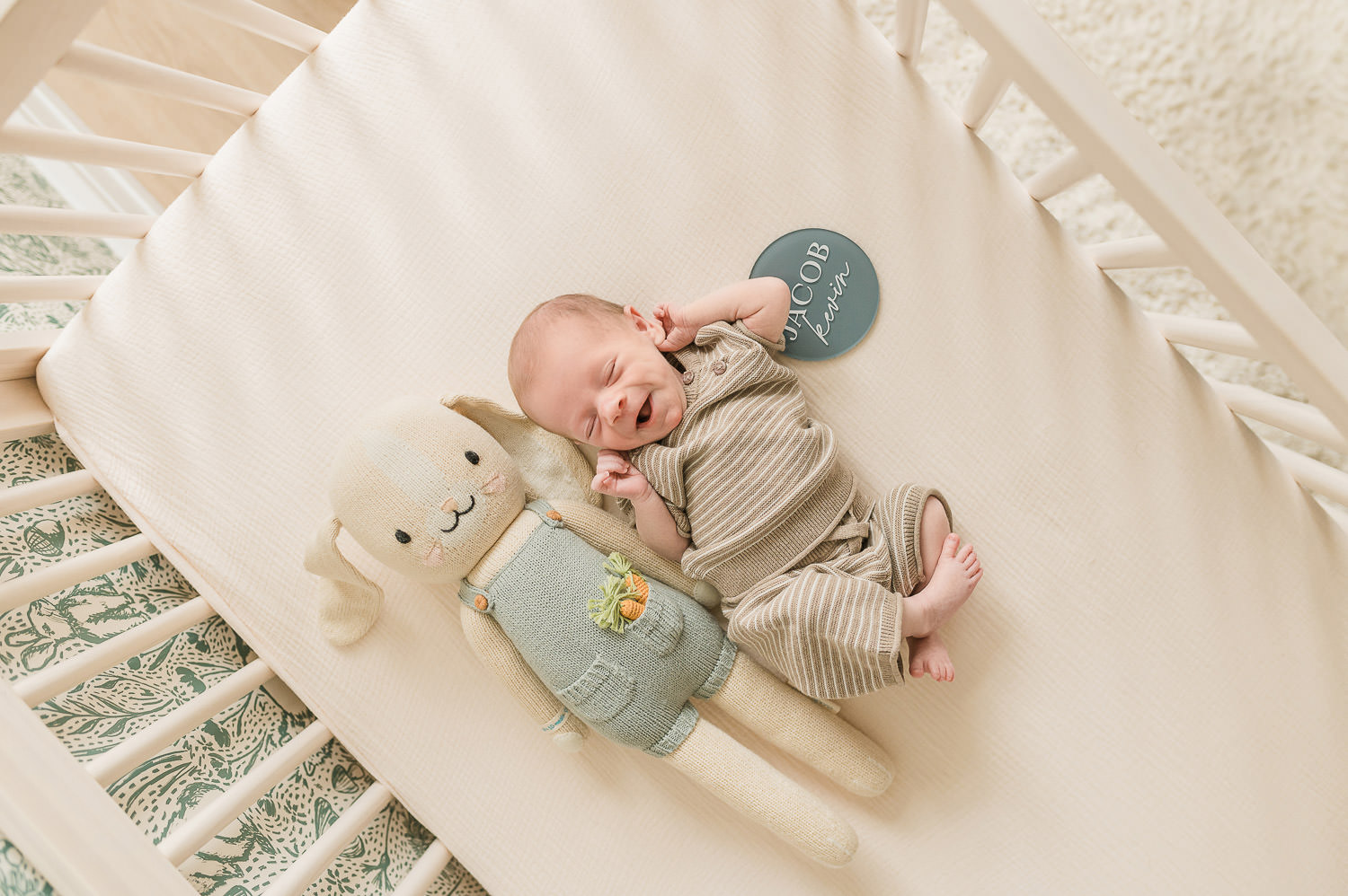 Newborn baby sleeping in crib with knit toy in nursery — in-home newborn photographer NJ