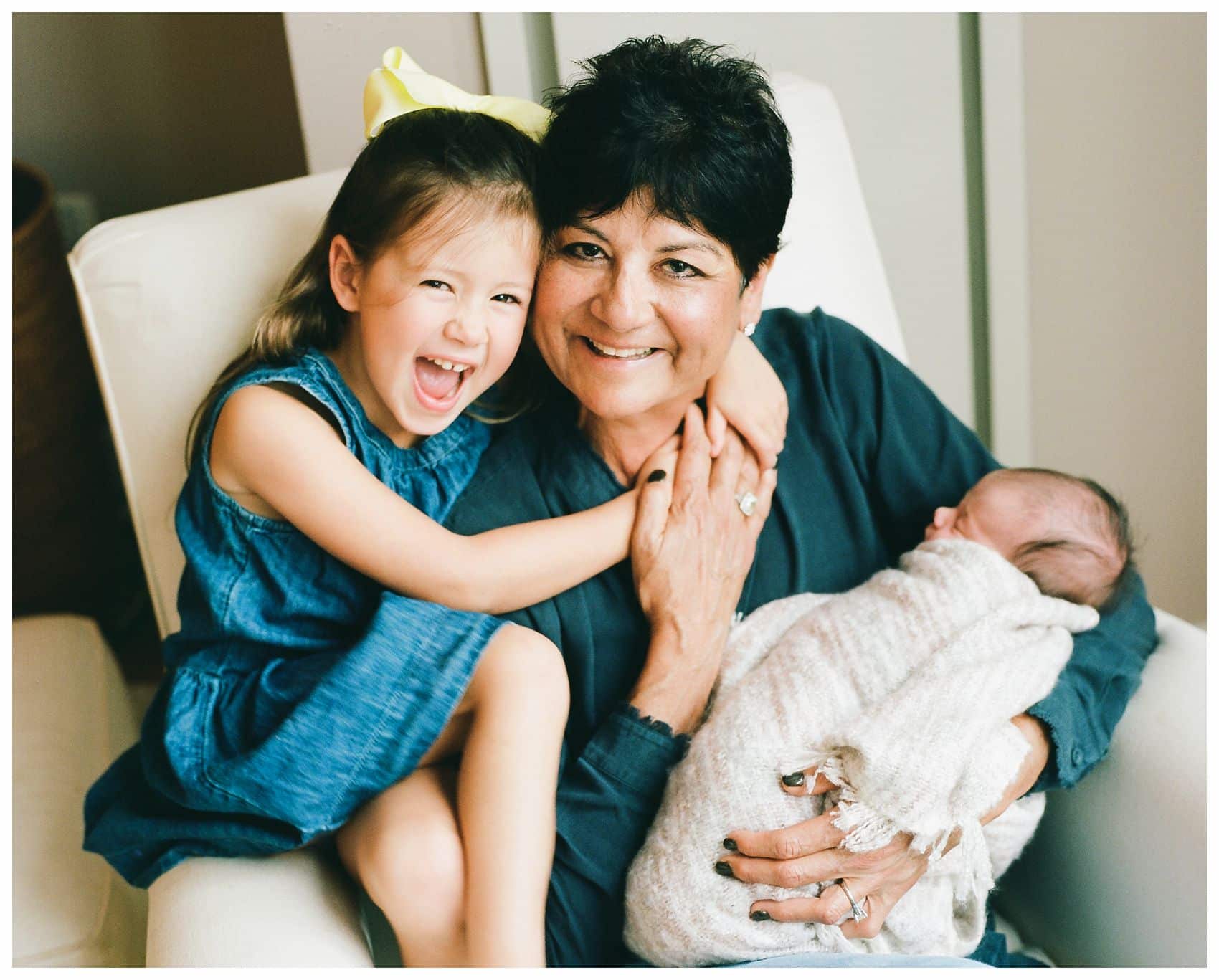 NYC Newborn Photographer Miriam Dubinsky shares best gift ideas for Mother's Day of a family portrait with grandmother hugging her grandkids