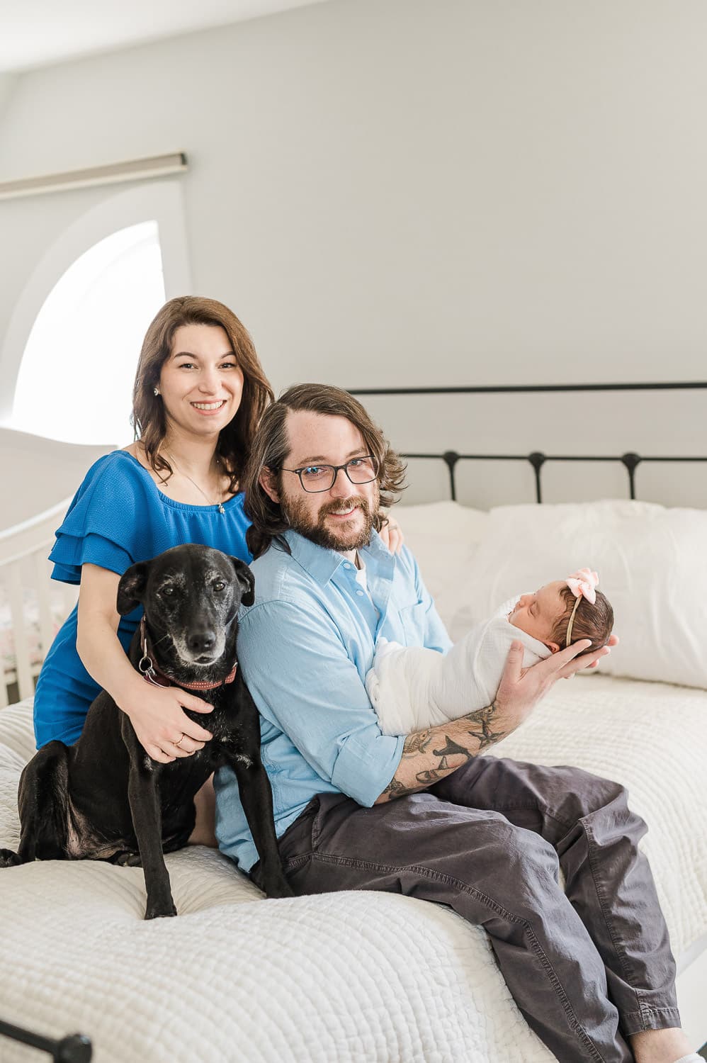 Upper East Side family with big black furry dog and newborn baby during in-home photo session