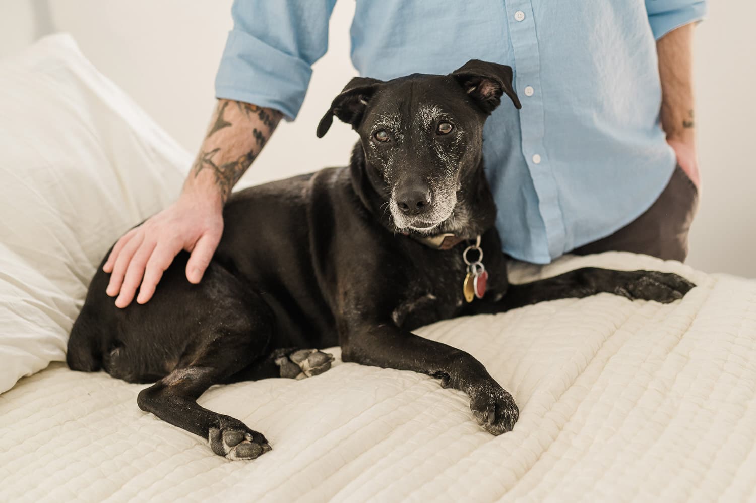 dad hugging his dog during family session in Manhattan home