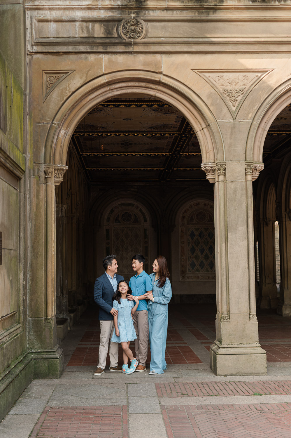 Fun family parents and children portraits under Bethesda Plaza arches in Central Park