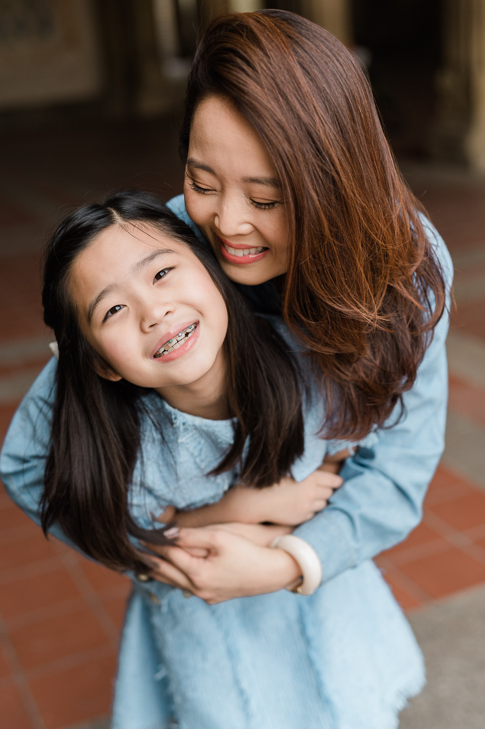 Intimate mother daughter moment of embrace during Central Park family photography session in NYC