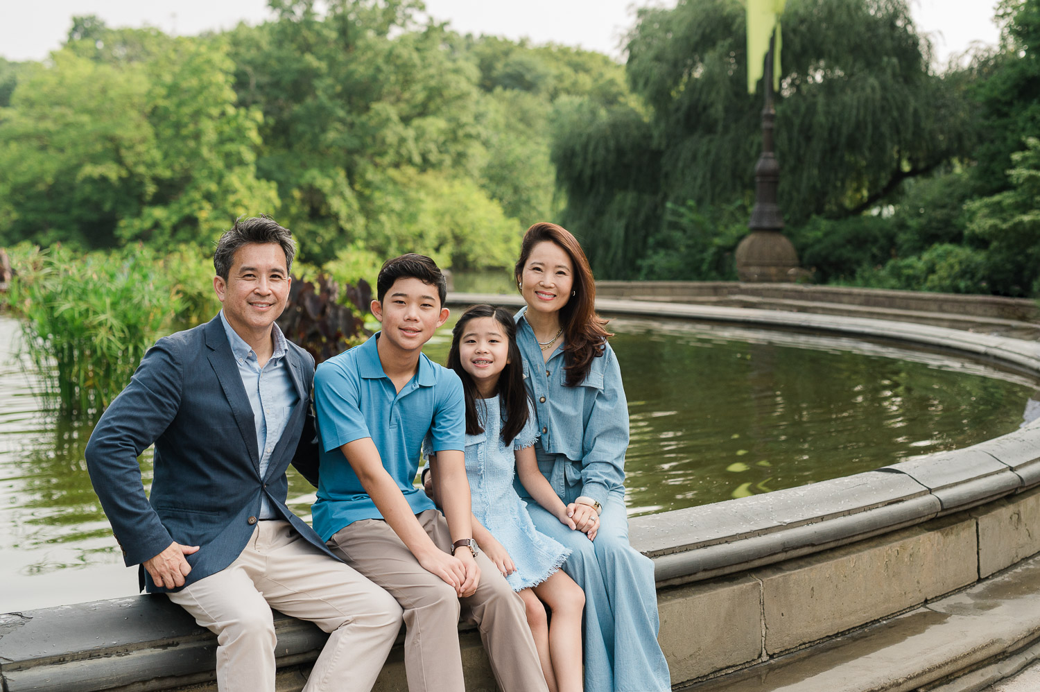 Central Park family portraits with relaxed parents and 2 children at iconic Bethesda Terrace fountain in Manhattan