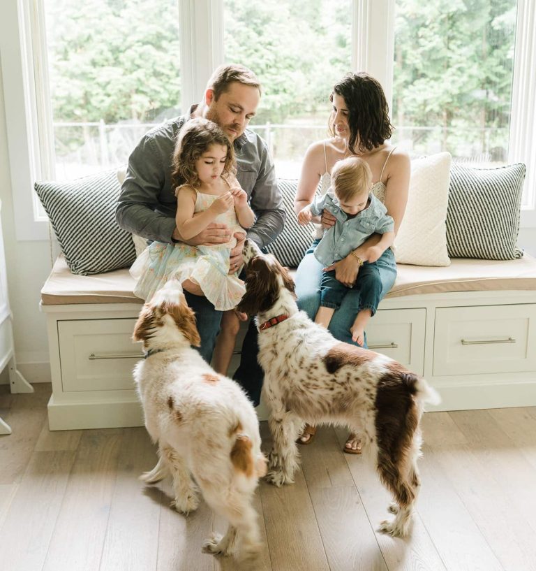 Parents with kids and dogs sharing playful moment in Summit, NJ