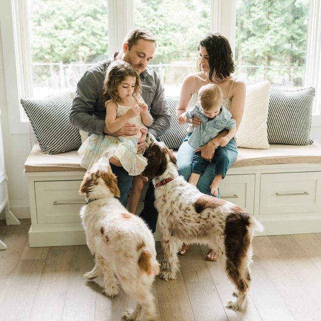 Parents with kids and dogs sharing playful moment in Summit, NJ