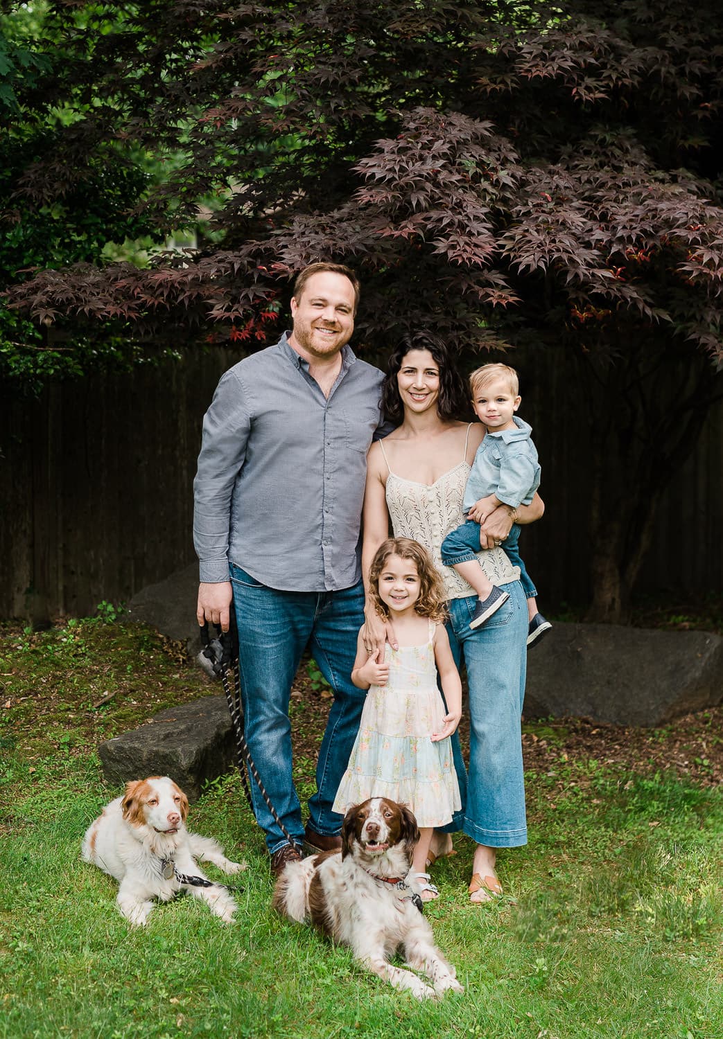 Candid moment with children and pets in Morris County backyard