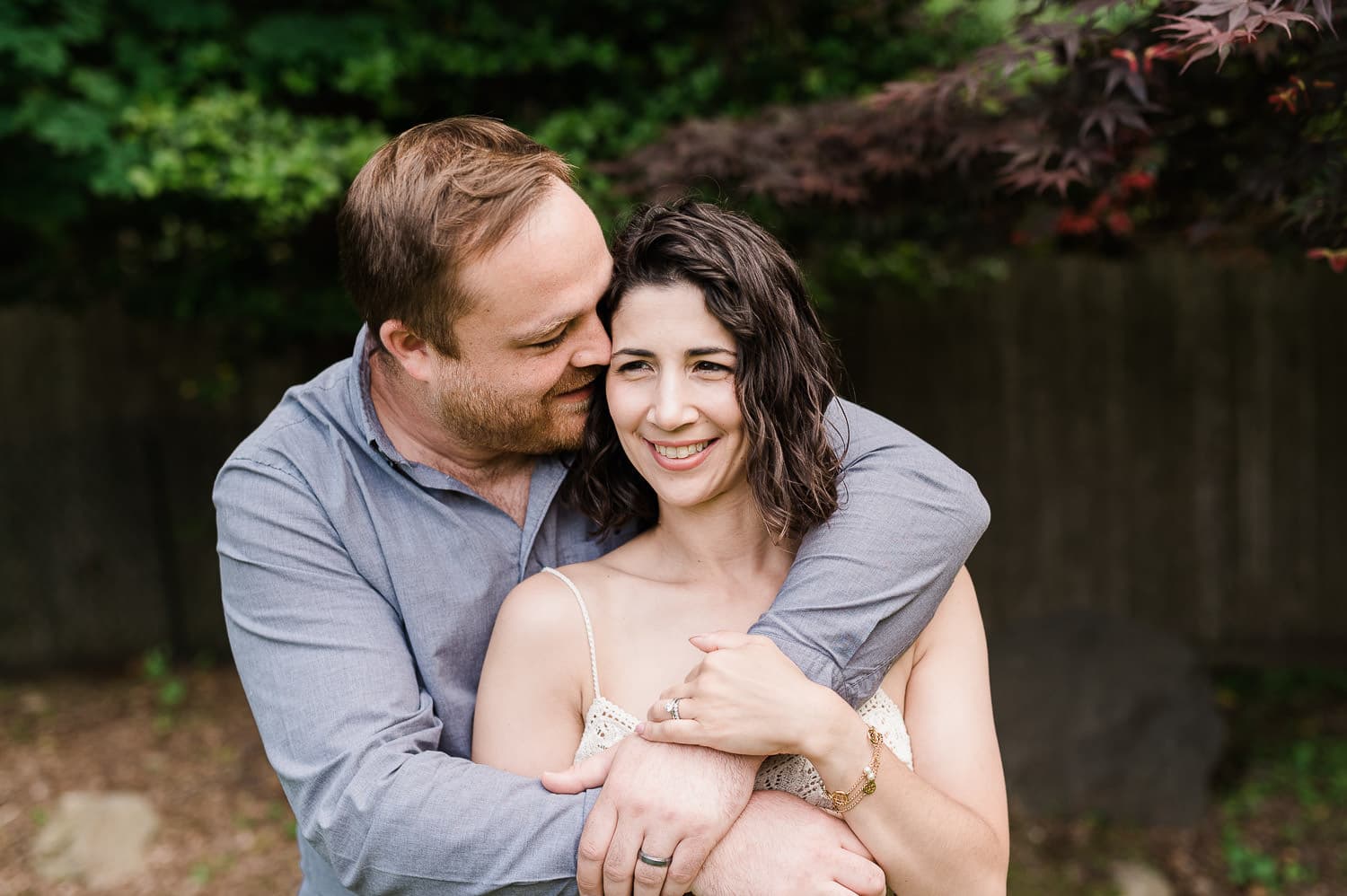 Dad hugging mom during family portrait session, Morris County, NJ