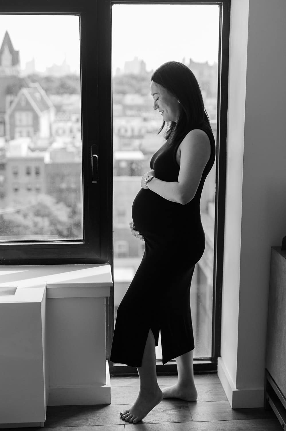 Indoor Park Slope maternity photography with natural window light and black and white silhouette portrait