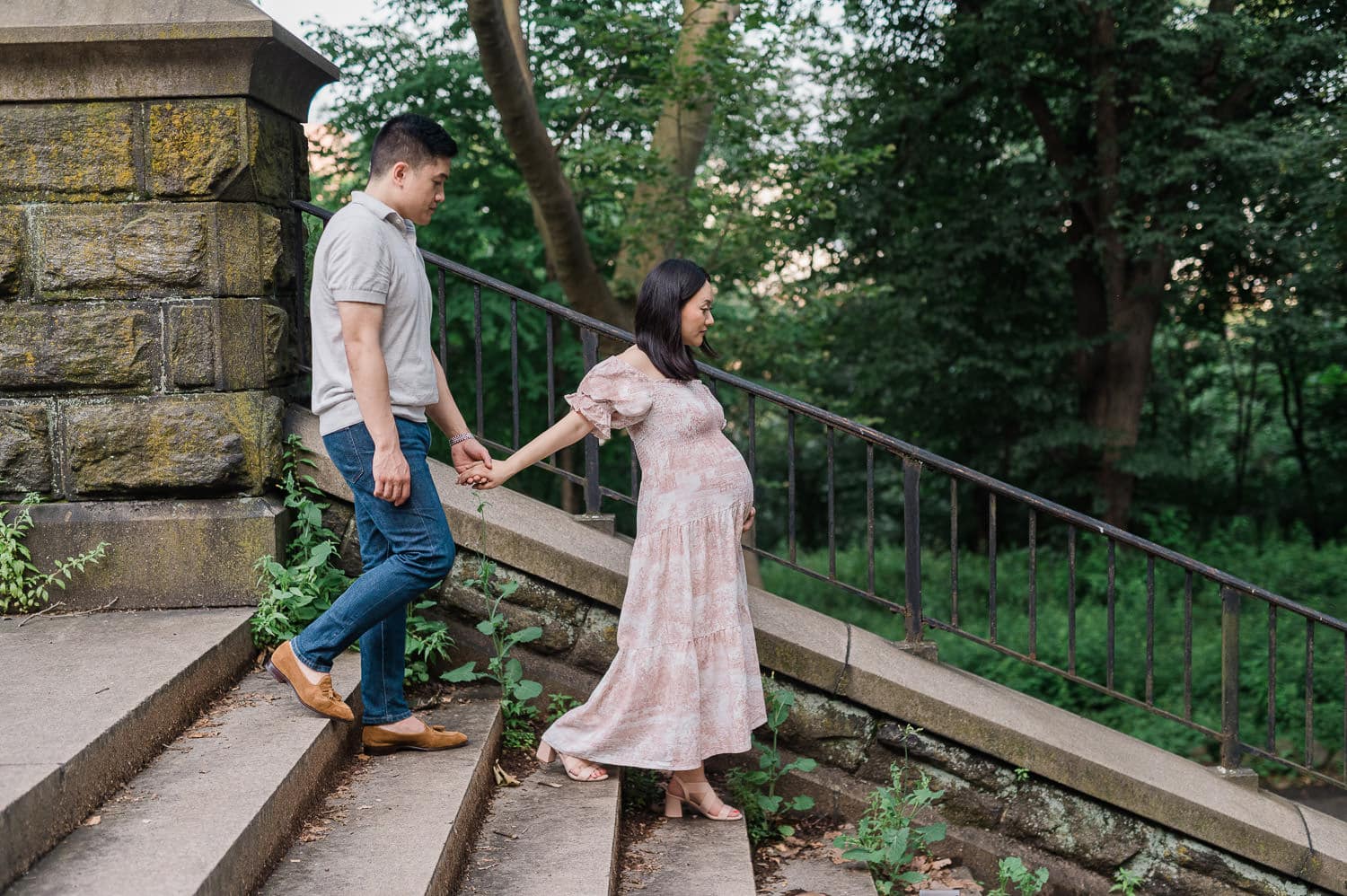 Expecting couple going down the steps maternity session in Prospect Park, Brooklyn.