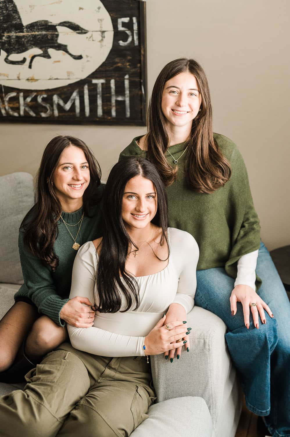 Three sisters together laughing during family and senior portrait session — in-home portraits by Miriam Dubinsky Photography