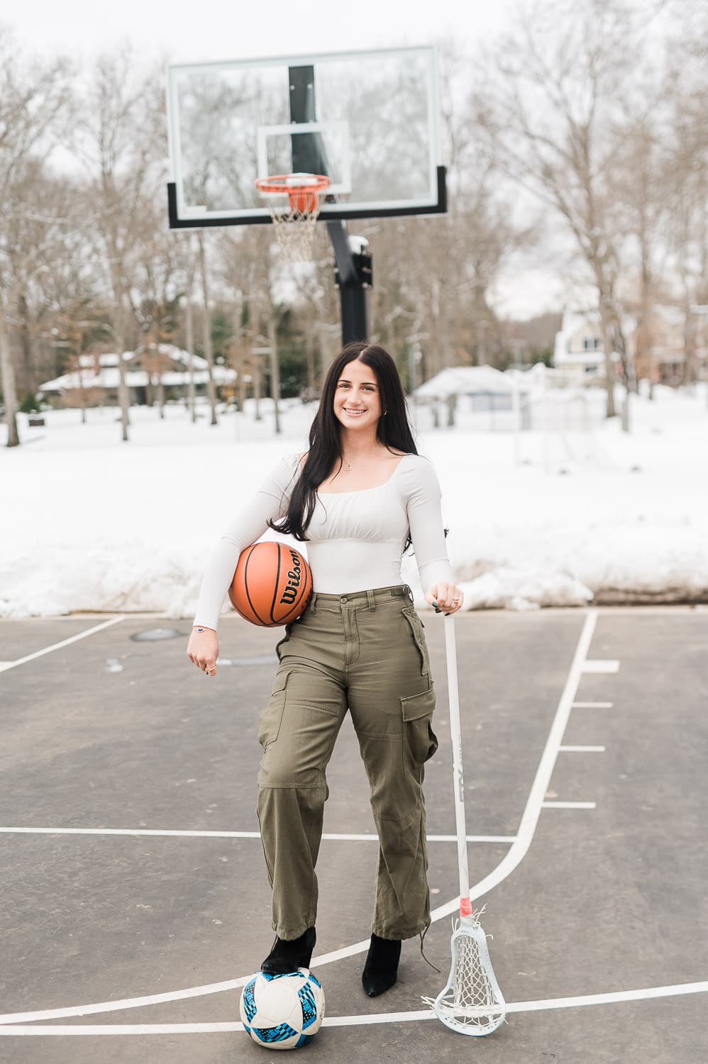 High school senior holding basketball soccer ball and lacrosse stick — senior portrait Bergen County NJ by Miriam Dubinsky Photography