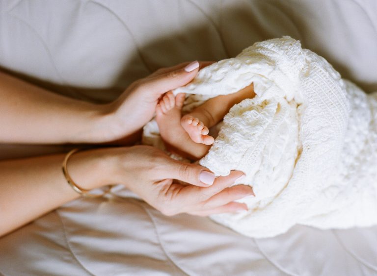 Mother holding newborn baby hands — lifestyle newborn photographer NJ